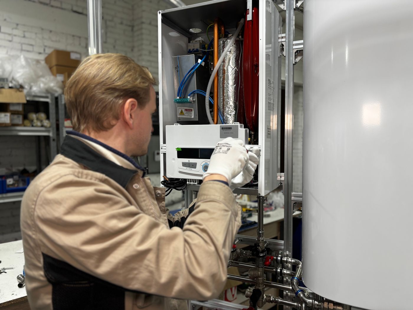 A gas engineer servicing a boiler