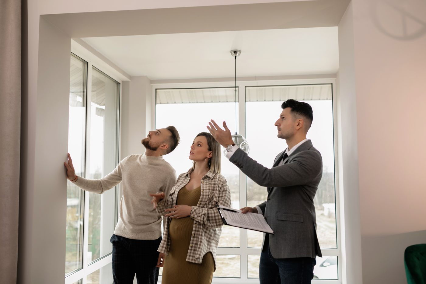 An estate agent showing a couple around a house