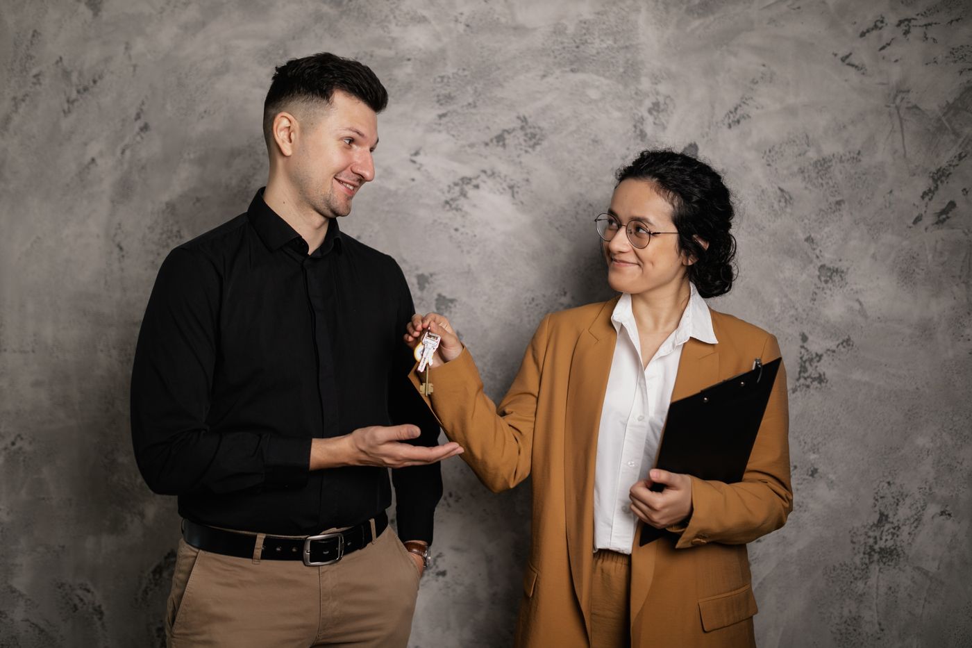 A letting agent handing keys to a tenant